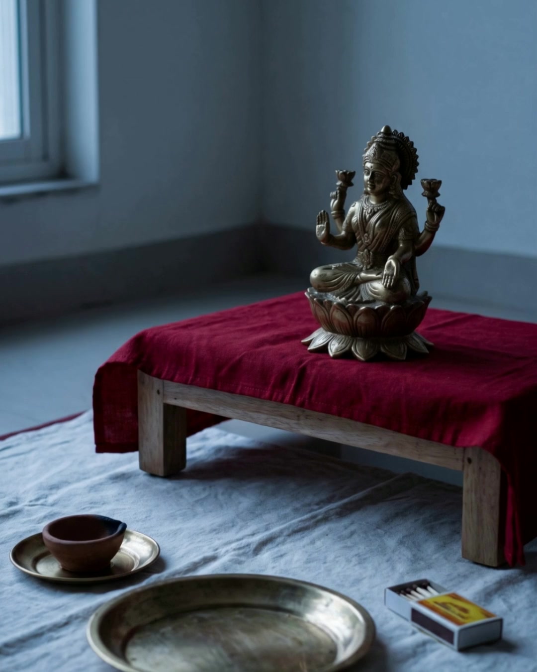 A Lakshmi Puja performed at home, from the unlit altar to the finished rite